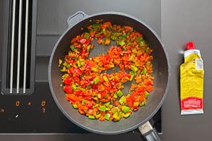 Tomatenmark in der Pfanne mit anbraten