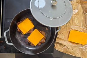 K&auml;se auf die Patties, dann jeweils noch ein Patty darauf stapeln und mit K&auml;se topppen